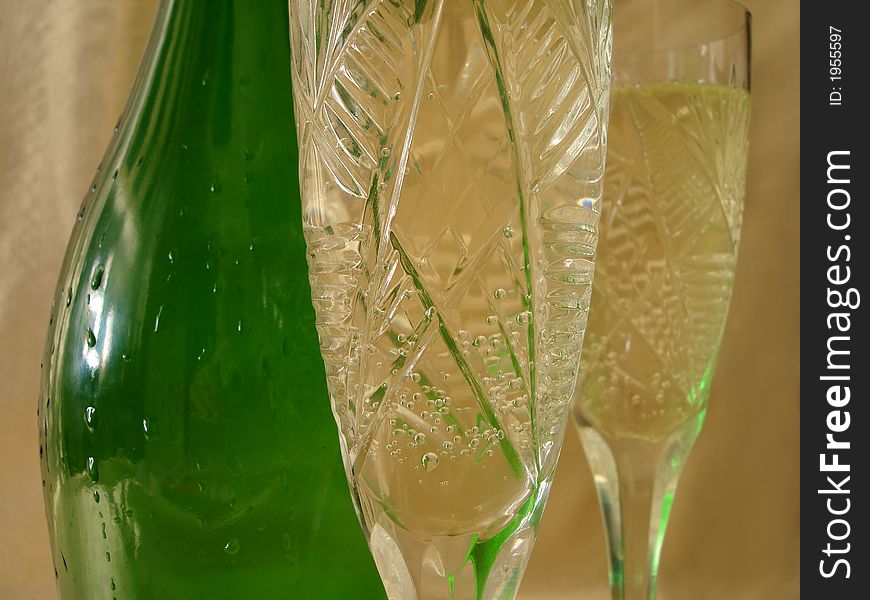 Close-up View Of Champagne Glasses With Bottle On Golden Backgro