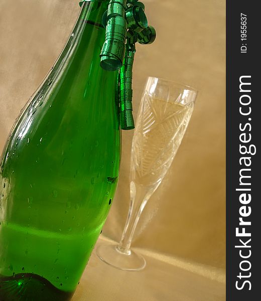 Close-up view bottle and Champagne glasses on golden background