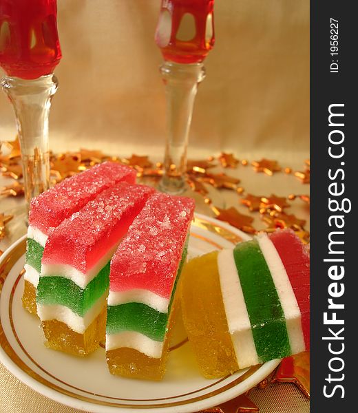 Celebratory table (Color Jelly cake on plate and two red glasses)