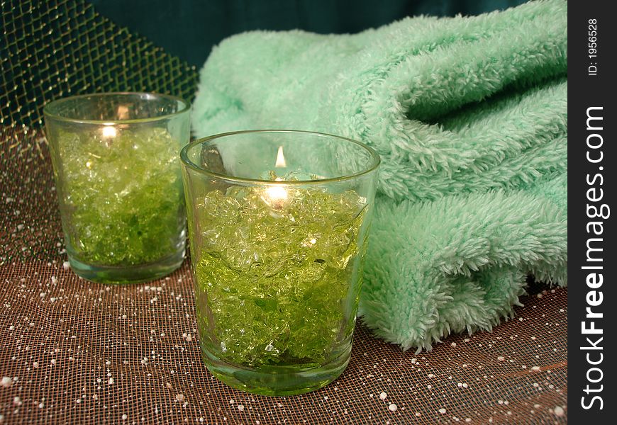 Spa essentials (green candles and towels)