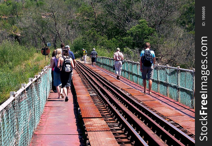 A tour group crossing an bridge. A tour group crossing an bridge