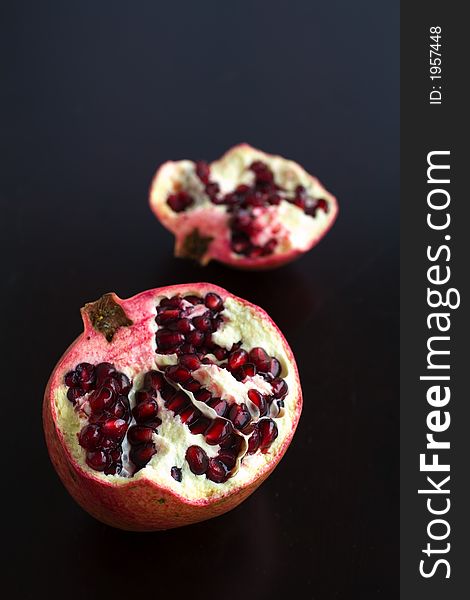 Pomegranates cut open with pomegrante seeds showing. Pomegranates cut open with pomegrante seeds showing