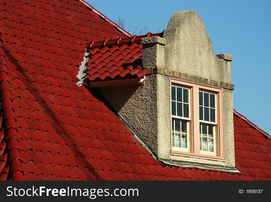 Red Spanish Tile roof with Dormer on a sunny day. Red Spanish Tile roof with Dormer on a sunny day
