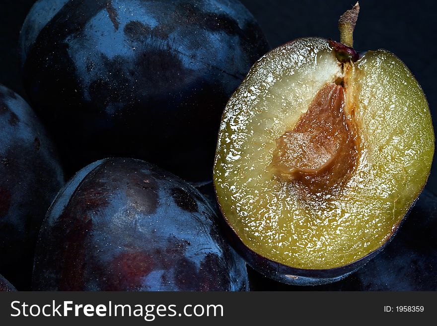 Dark blue ripe fleshy plums