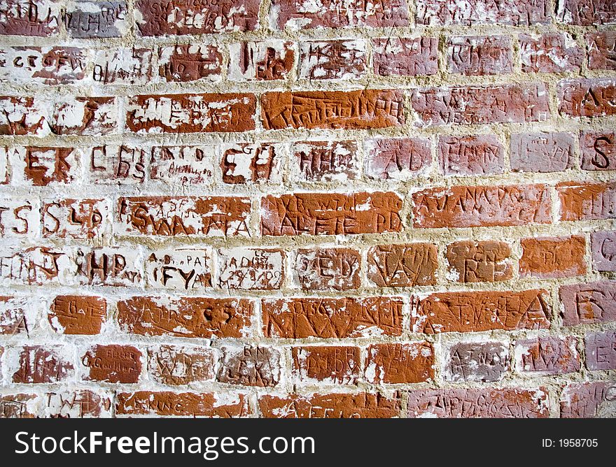 Letters carved in a bricks wall. Letters carved in a bricks wall