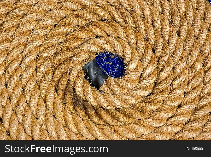 Rolled up coil of thick rope. The coil is neat and circular. Rolled up coil of thick rope. The coil is neat and circular.