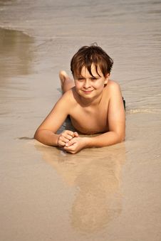 Boy Iy Lying At The Beach Royalty Free Stock Image