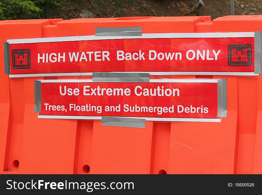 High Water sign for boats on an orange barrier. High Water sign for boats on an orange barrier.