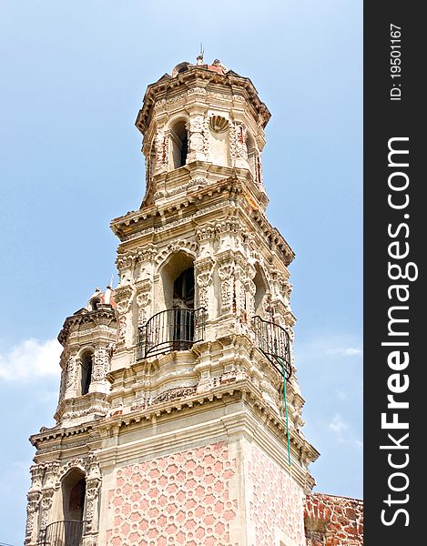 A Catholic church spire rises above the streets of Mexico City.