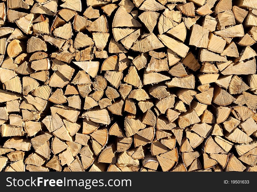 Chopped and stacked pile of pine and birch wood. Texture, background. Chopped and stacked pile of pine and birch wood. Texture, background