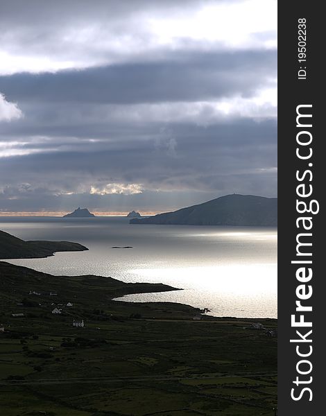 Kerry scenic view of the Skellig rocks in ireland with mountains against a beautiful blue cloudy sky