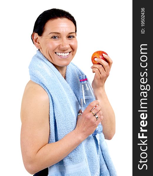 Middle aged woman with water and an apple staying in shape. Middle aged woman with water and an apple staying in shape