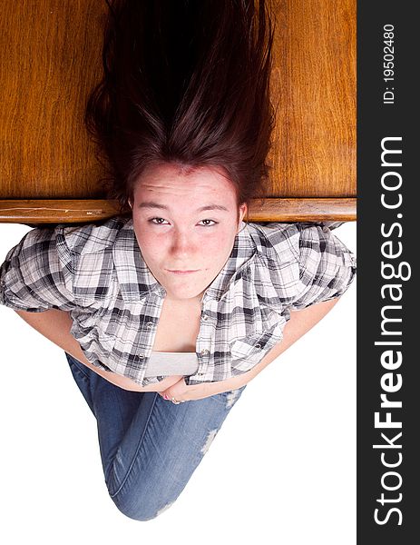 A photograph of a teenage girl upside down with her hair floating.