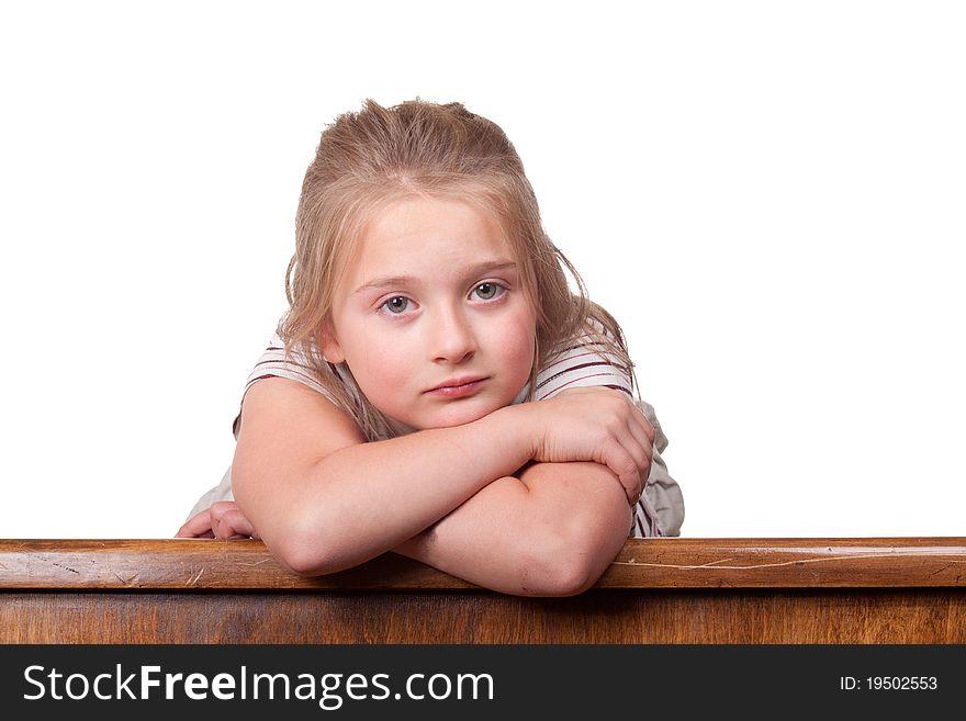 A photograph of a young girl lying on top a desk looking a little sad. A photograph of a young girl lying on top a desk looking a little sad.