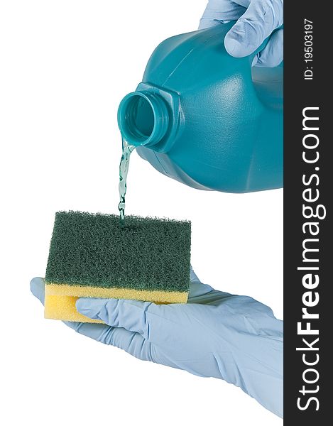 Hands with gloves tossing liquid on a scouring pad. Hands with gloves tossing liquid on a scouring pad