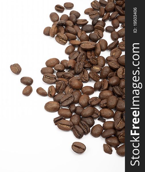 Coffee beans spilled on a white background