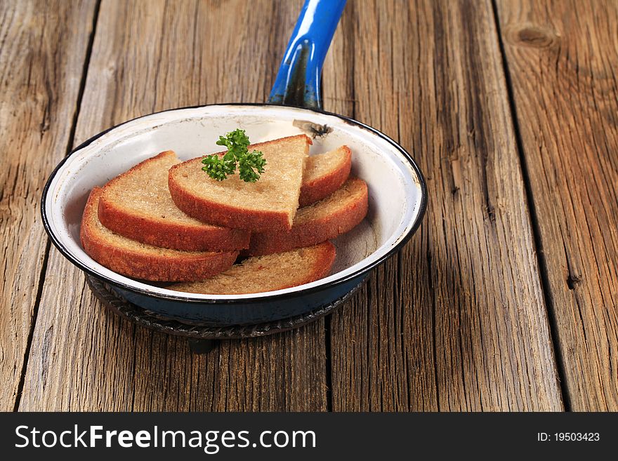 Slices of fried bread in a pan