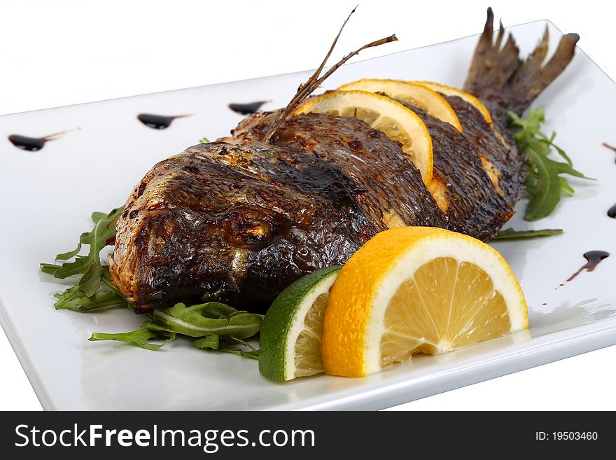 Fried fish with fresh herbs and lemon
