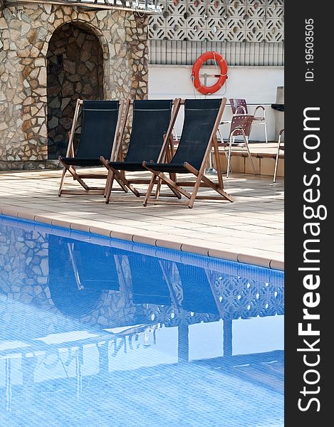 Pool image with beach chairs and palms. Pool image with beach chairs and palms