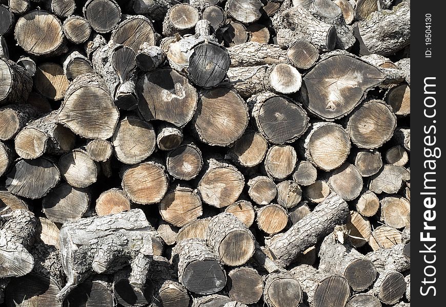 Grey firewood pile closeup background. Grey firewood pile closeup background.