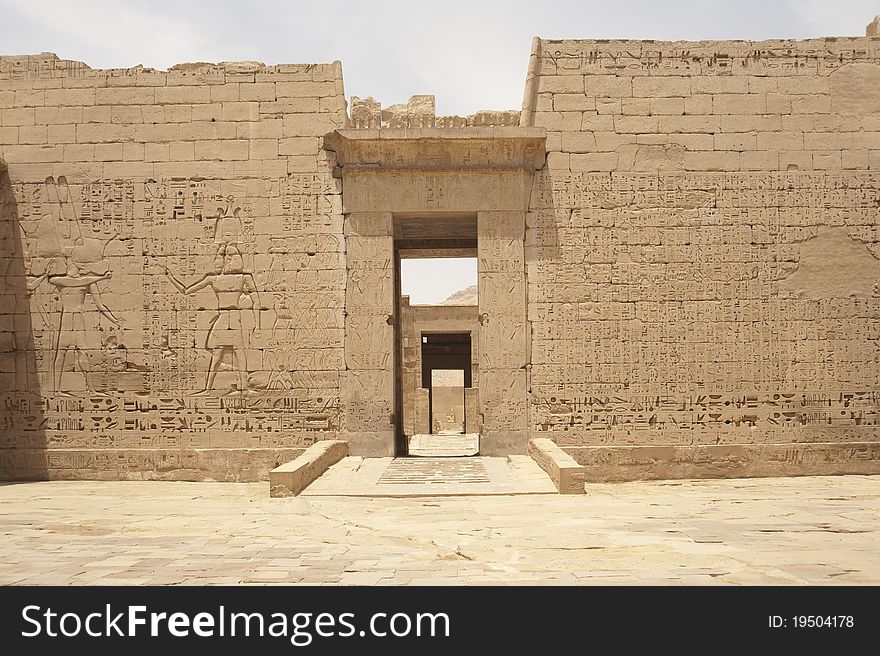 Egyptian hieroglyphic carvings on a wall at the Temple of Medinat Habu. Egyptian hieroglyphic carvings on a wall at the Temple of Medinat Habu