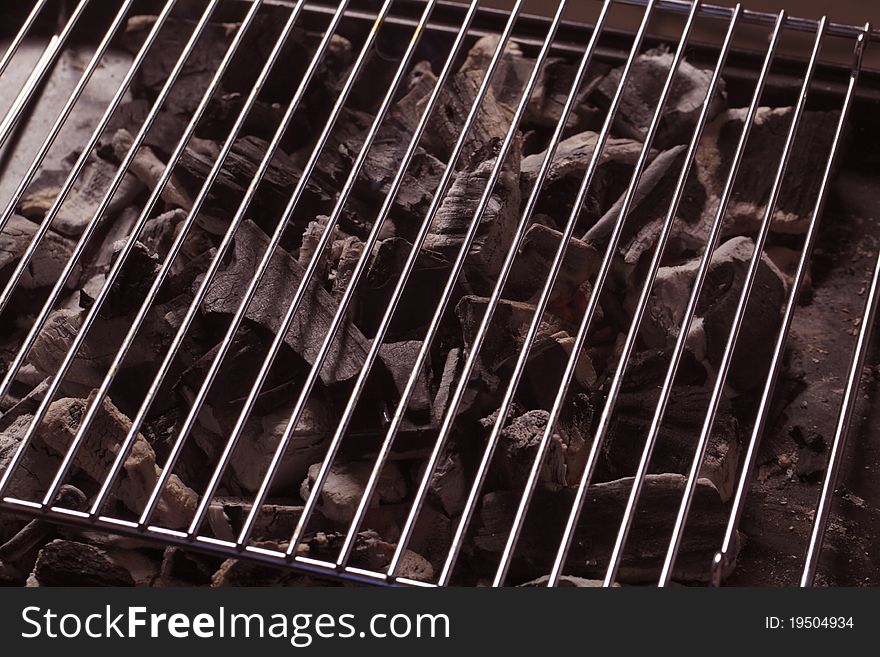 Charcoal under a barbecue grid