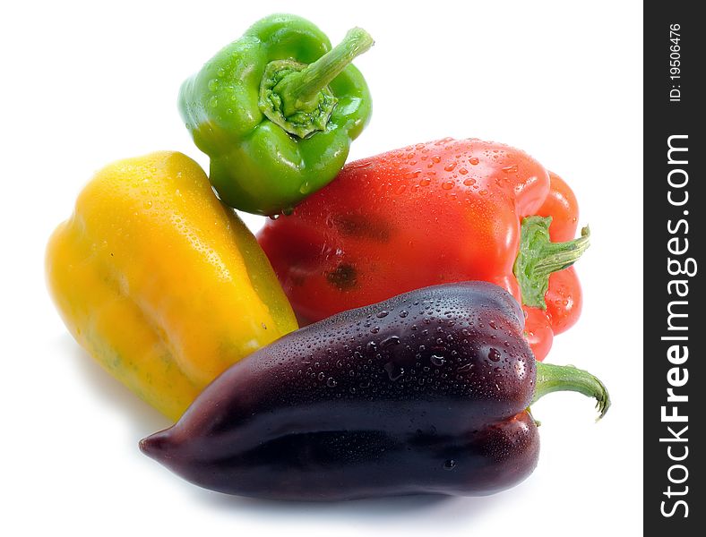 Red,green,yellow and purple pepper on a white background