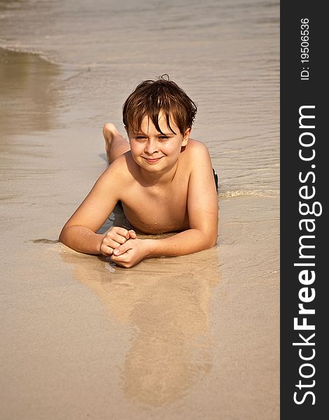 Boy iy lying at the beach