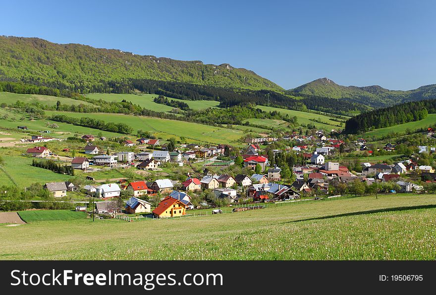 Farmland, small town and forested hills in Sulov. Farmland, small town and forested hills in Sulov