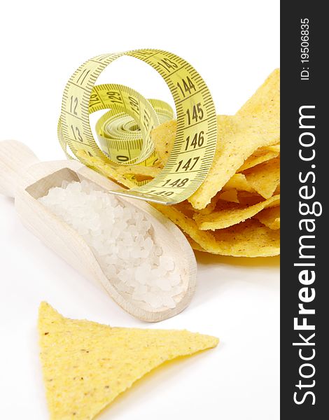 Tortilla chips, measuring tape and wooden spoon of salt. Tortilla chips, measuring tape and wooden spoon of salt