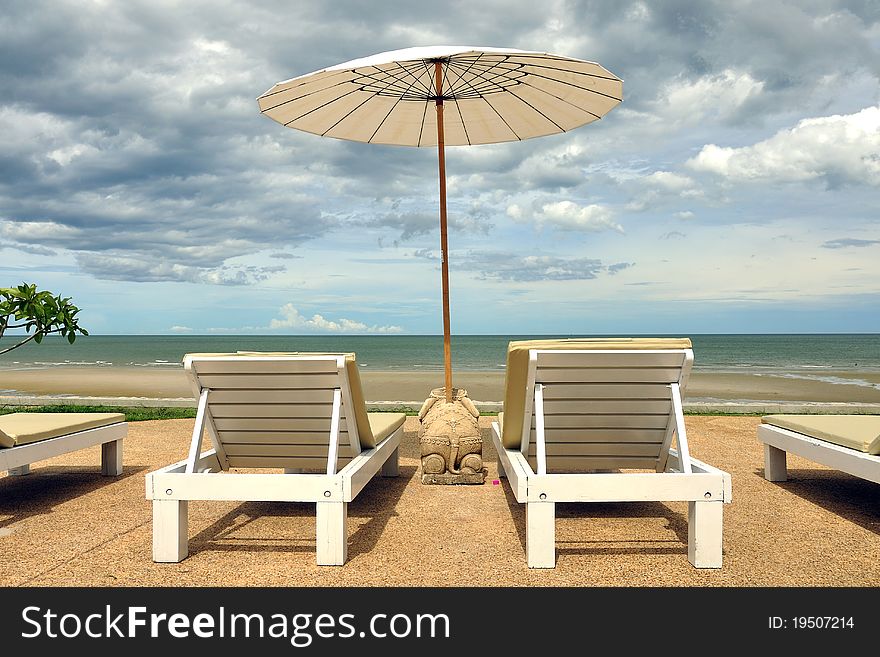 Beach chair on the beach with cloudy sky