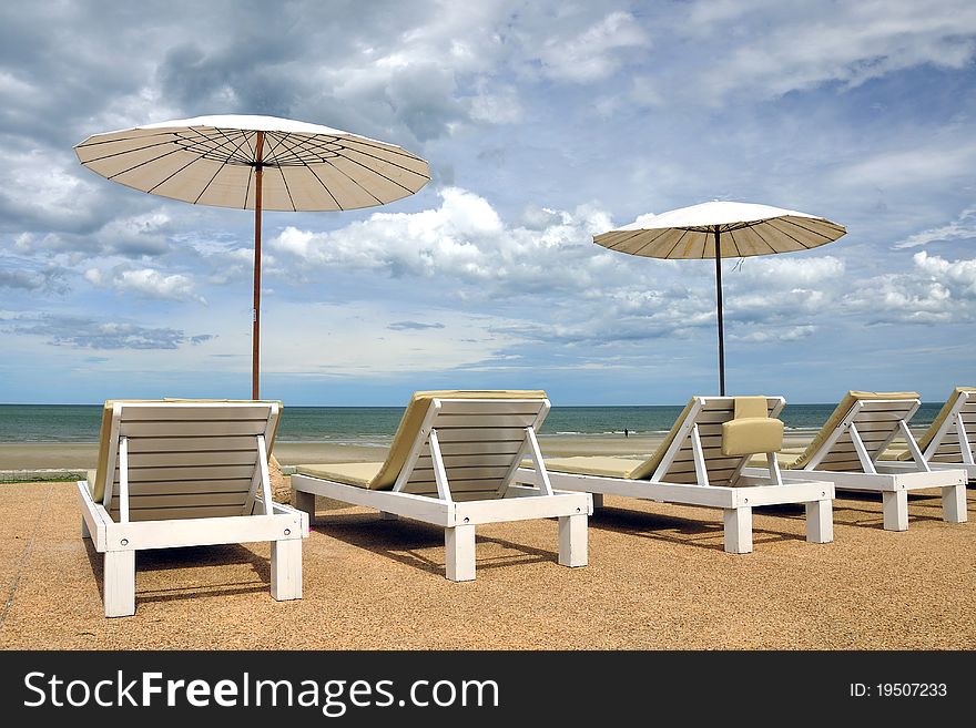 Beach chair on the beach with cloudy sky