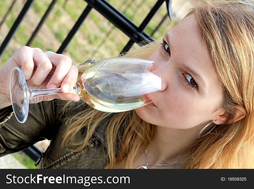 Beautiful young woman drinking white wine. Beautiful young woman drinking white wine