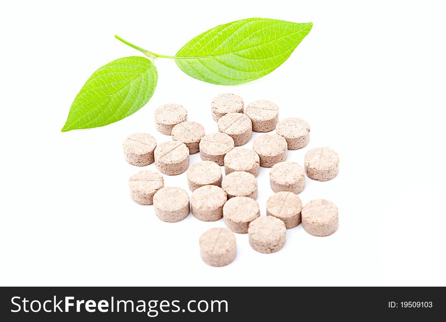 Pills with green leaf isolated on a white background. Herbal Medicine.