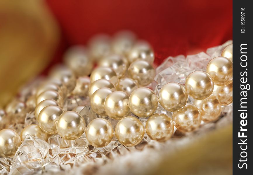 Elegant pearls over ice with ribbon very shallow depth of field