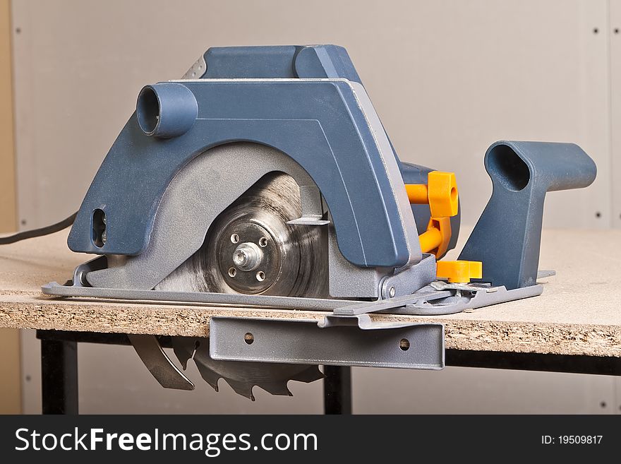Close-up of a circular saw on the table.