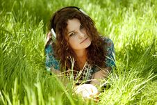 Redhead Girl With Headphone At Green Grass Royalty Free Stock Photography Redhead Girl With Headphone At Green Grass Royalty Free Stock Photography
