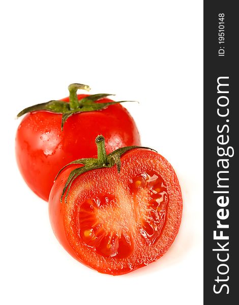 Fresh garden tomatoes with water drops on a white. Fresh garden tomatoes with water drops on a white.