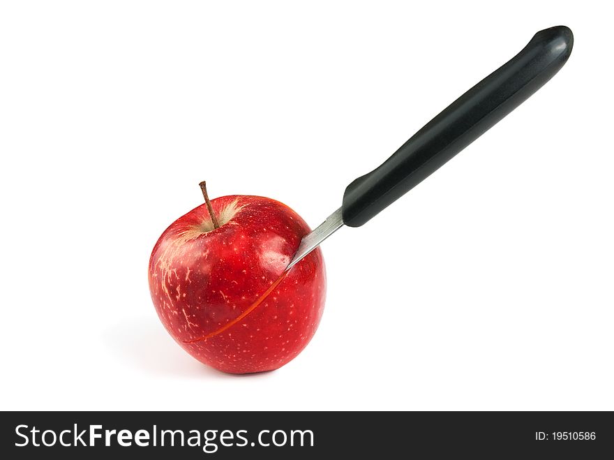 Knife cuts apple isolated on a white background