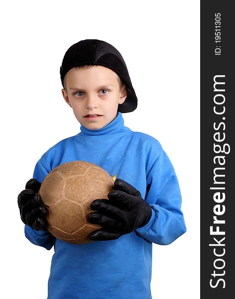 The boy with a ball in gloves a black cap. The boy with a ball in gloves a black cap.