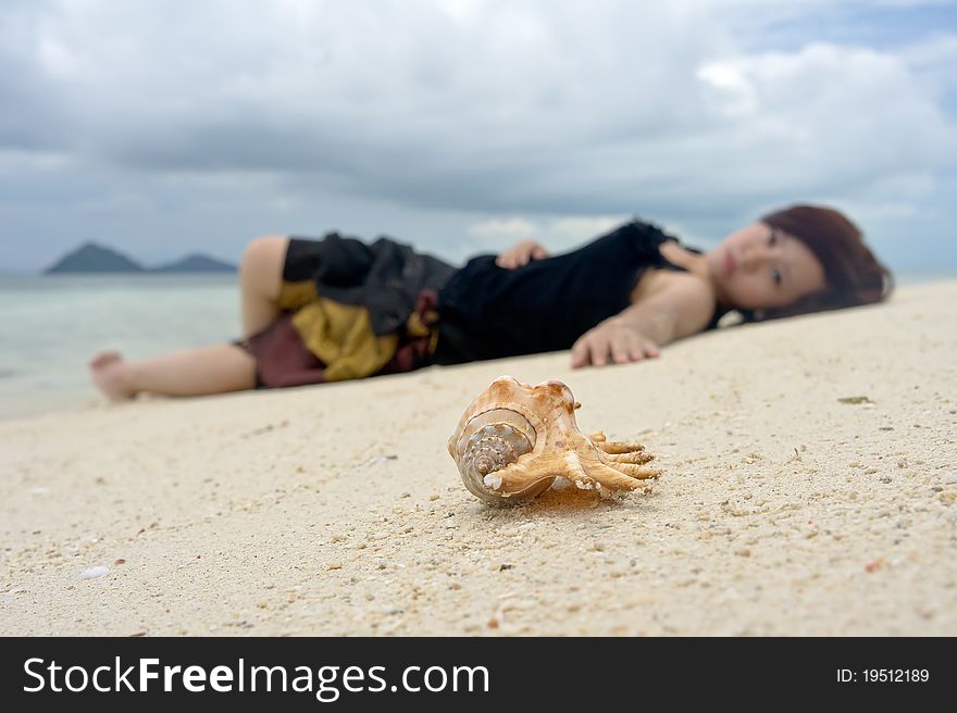 Relaxed young woman lay on beach sand