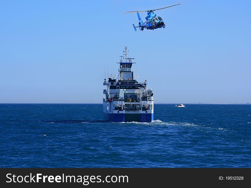 Oceanographic ship sailing and rescue helicopter