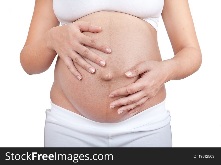 Pregnant woman hold hands on a belly isolated