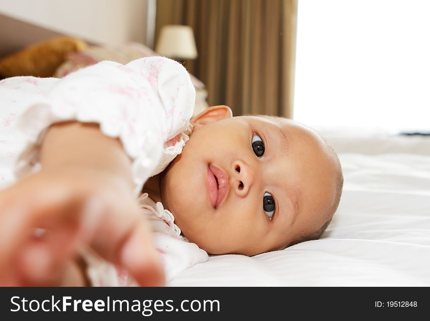 Cute asian ethnic baby girl lay on bed. Cute asian ethnic baby girl lay on bed