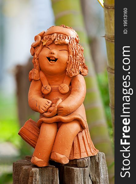 Pottery statuette of happy girl in the park