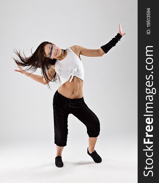 Cool looking dancer posing on a grey background. Cool looking dancer posing on a grey background