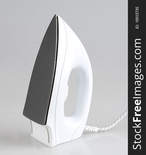 White electric iron isolated on grey background