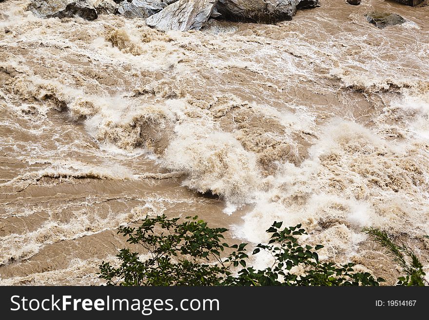 The turbulent currents of golden sand river, which is the upstream of yangtze river, near lijiang, yunnan province, southwest china. The turbulent currents of golden sand river, which is the upstream of yangtze river, near lijiang, yunnan province, southwest china.