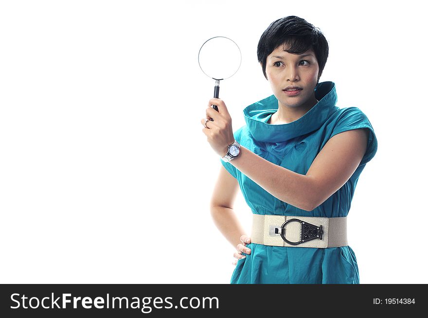 A women in green suite with magnifier in hand in isolated white background
