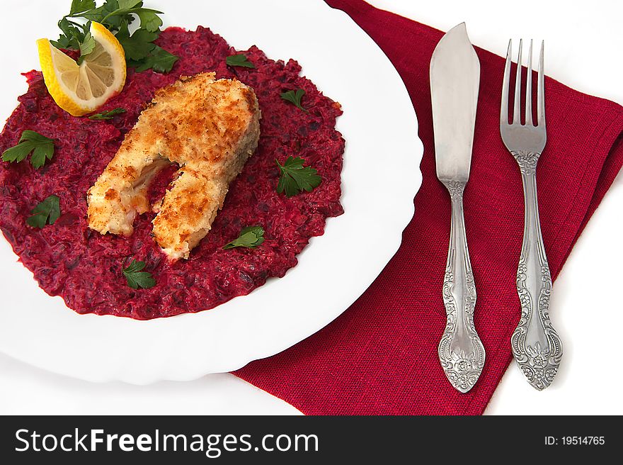 Fish stake with beet sauce, lemon and parsley on the white background. Fish stake with beet sauce, lemon and parsley on the white background